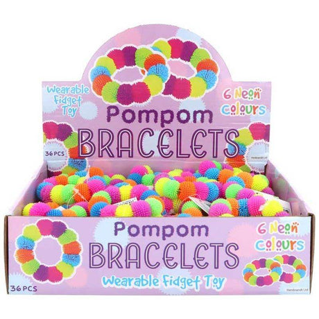 Colorful pompom fidget toy bracelets on display box with neon colors.