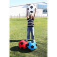 Large outdoor inflatable Mega Football in assorted colors on grass, perfect for kids and garden play.